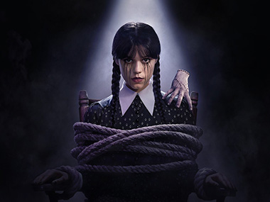 Jenna Ortega as Wednesday Addams holding an umbrella in the rain, from Netflix’s Wednesday series filmed using virtual production at Ashford Studios.
